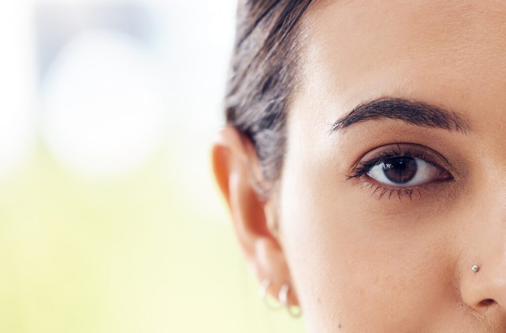 Woman stares in camera after receiving eyebrow tinting in Leawood