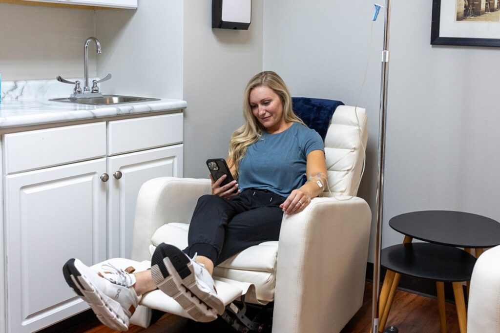 woman sitting in medspa recieving IV Therapy in Leawood