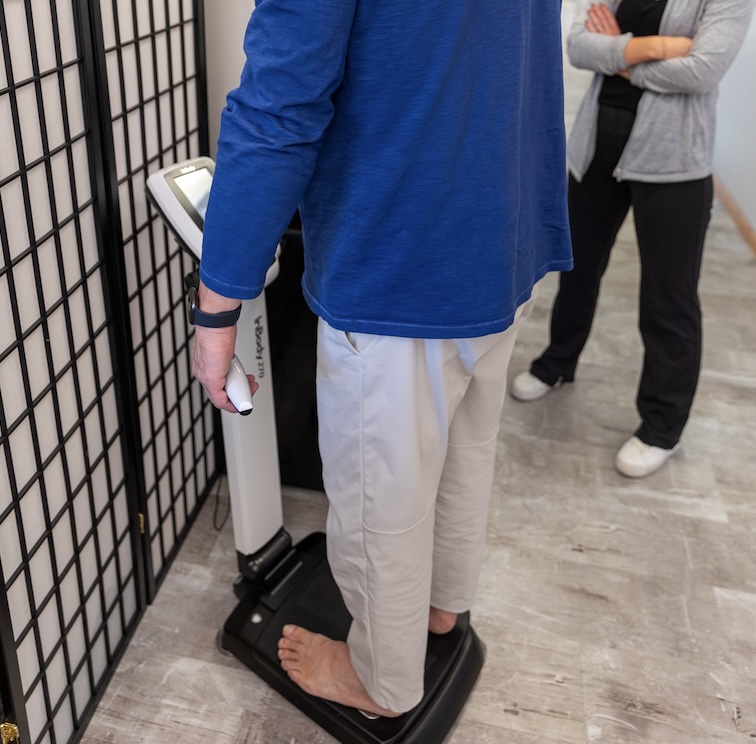Man stepping on InBody Body Composition analysis to track his progress with medical weight loss in Lawrence.